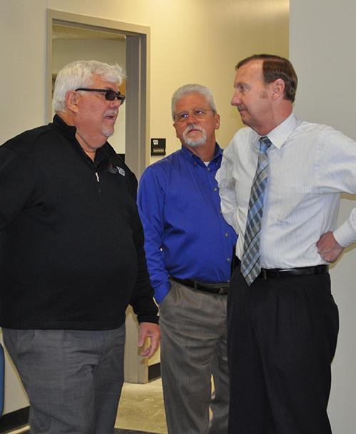 Three men talking at the open house