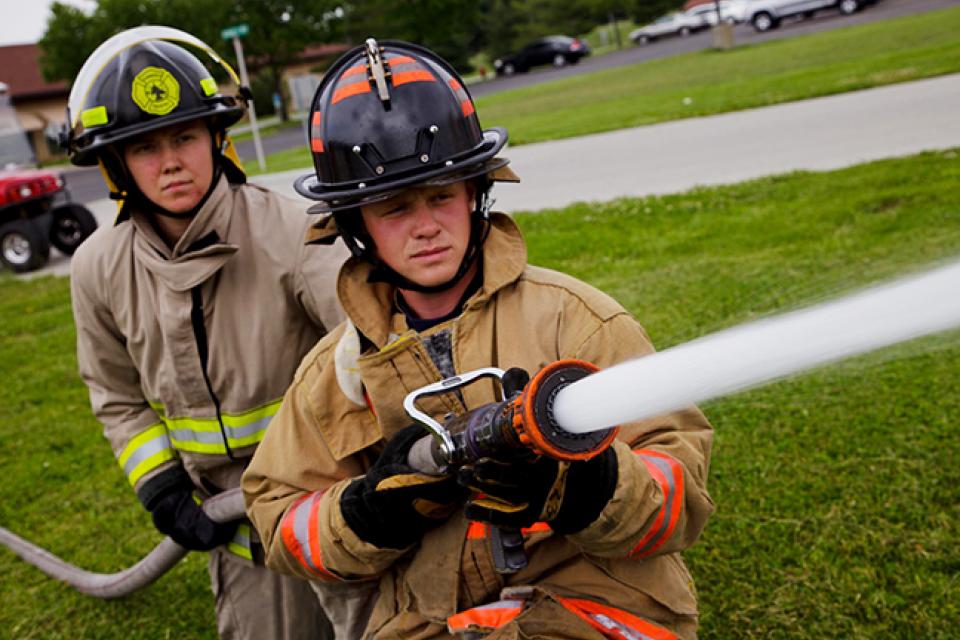 Firemen holding a firehose