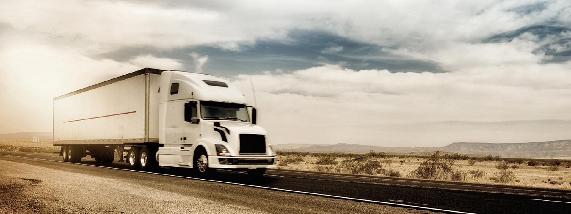 A semi-trailer drives on a road.