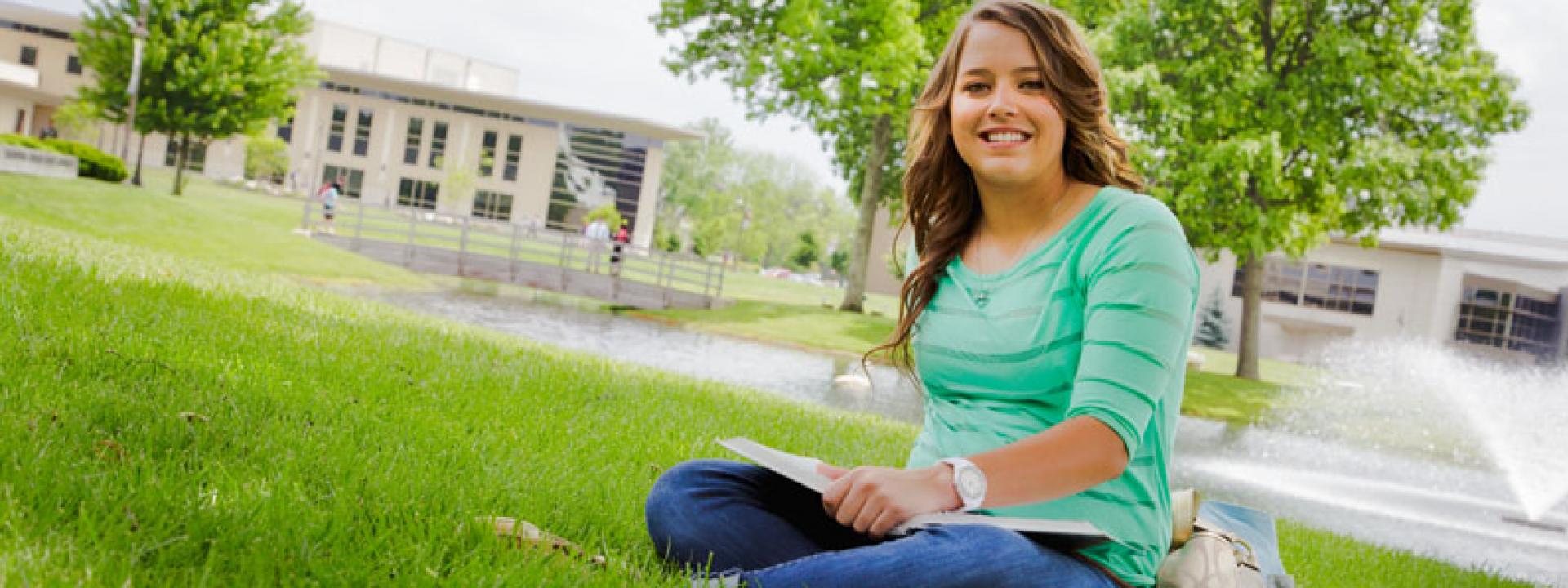 COTC student sitting in grass
