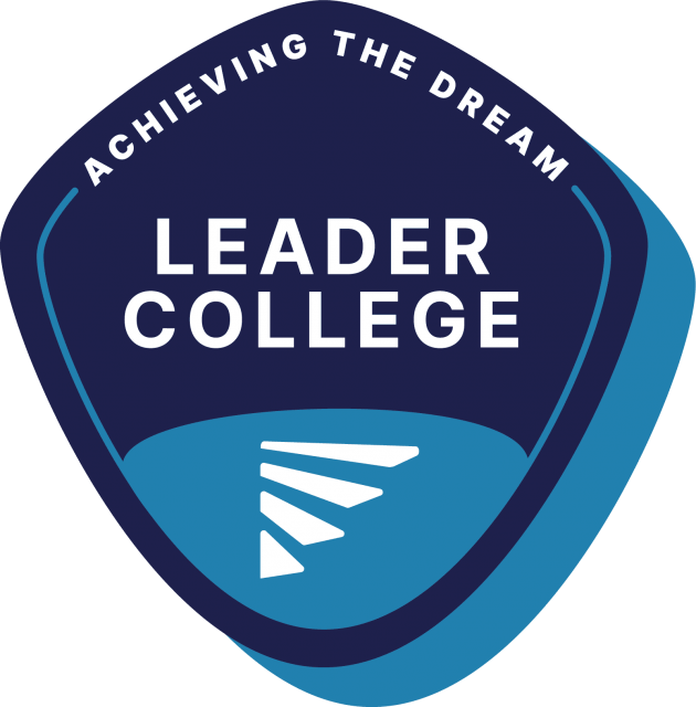 A badge with "Leader College" on it.