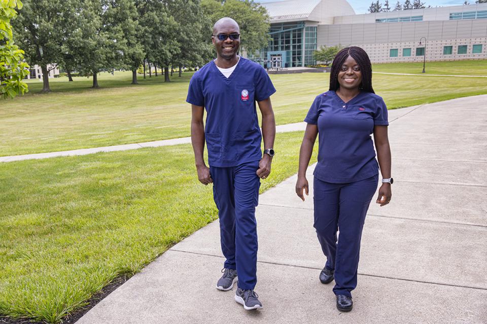Ben Anyigbavor and his wife, a COTC alumna, walk on the Newark campus.