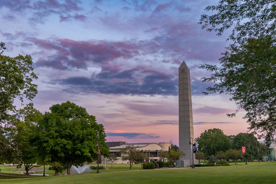 The lawn of the Newark campus with the bell tower in the foreground and the Reese Center behind.