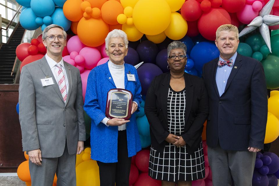 Paddy Kutz holds her award standing next to Ohio State Newark Dean/Director Matthew J. Smith, Vorley Taylor, and COTC President John M. Berry.