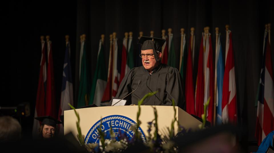 COTC alumnus Timothy Young stands at the podium delivering the keynote speech.