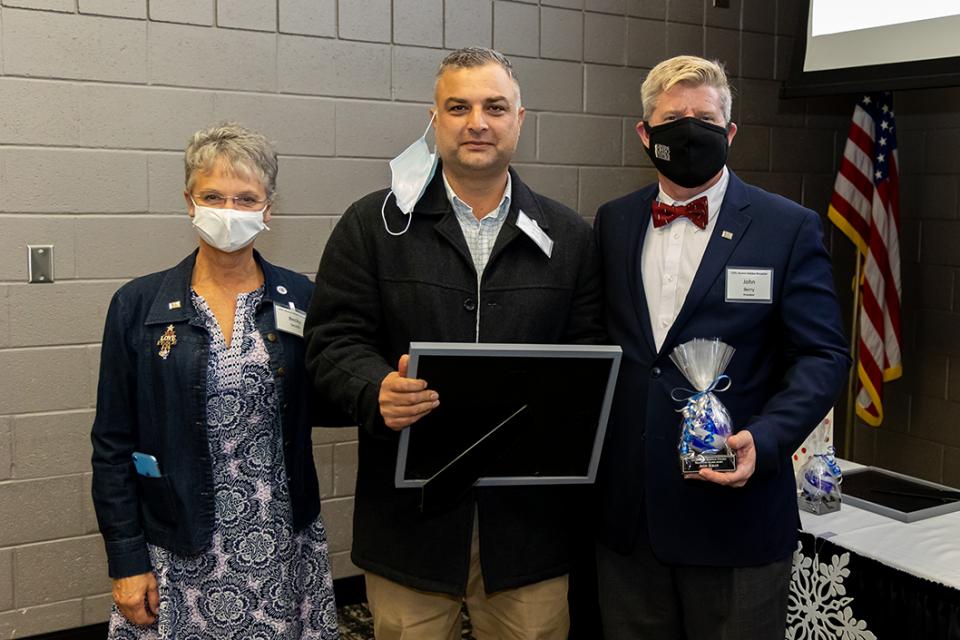 Asif Khan receives his award from COTC Alumni Council President Becky Smith  and COTC President John Berry