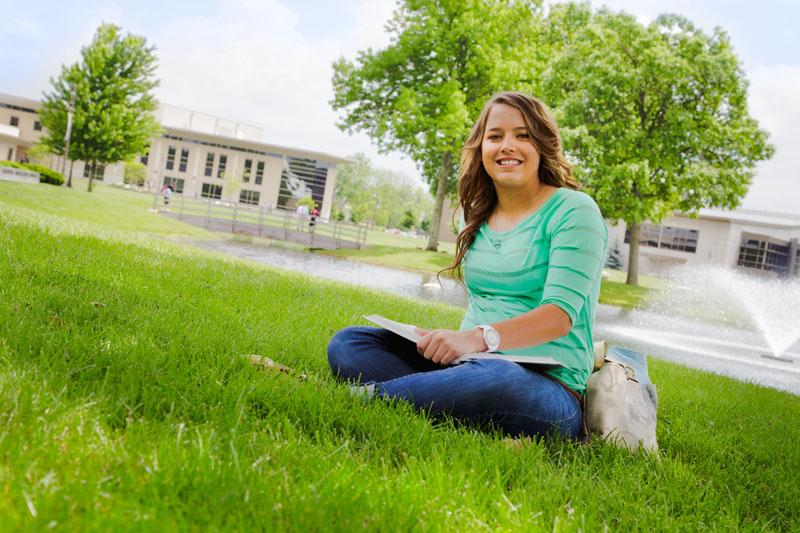COTC student sitting in grass