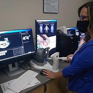 Caucasian woman using ultrasound simulator equipment 