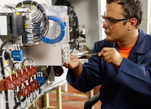 Image of a man wiring a circuit board