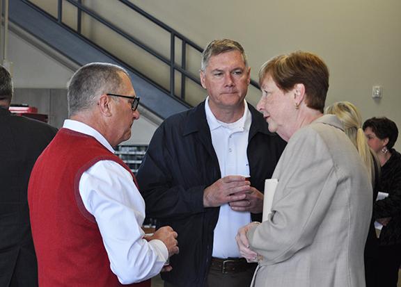 Three people mingling at the open house