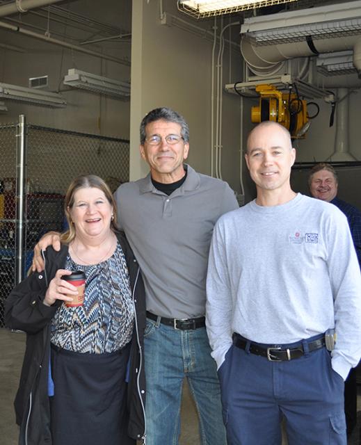 Three people posing at the open house
