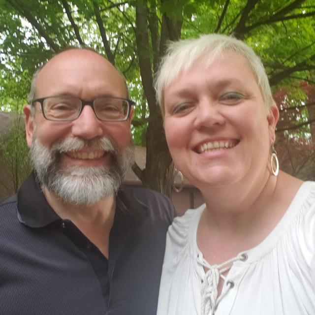 Percella Gualtieri (right) with her husband, Jim smiling at camera.
