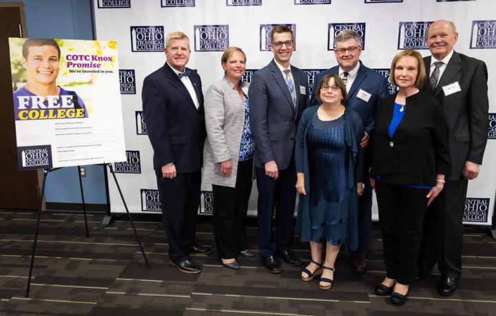 3 women and 4 men standing together next to Knox Promise poster