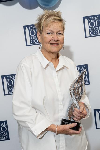 Sandra Walker holds her Legends of Loyalty Award trophy.