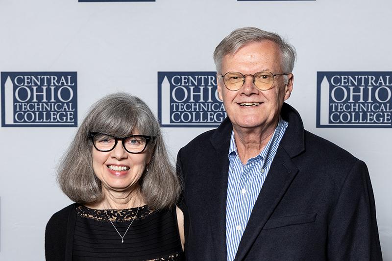 Portrait of Connie Hawk standing next to her husband.