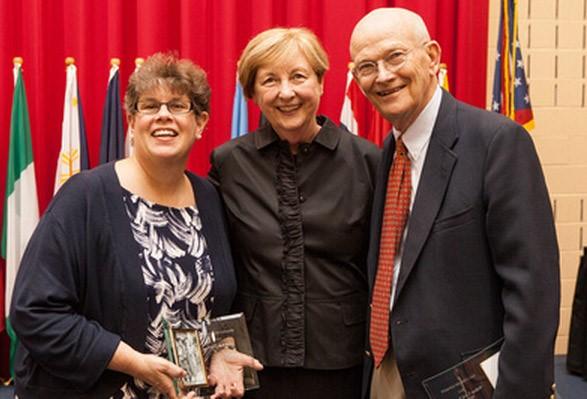 Ellen Robinson and William McConnell stand on either side of COTC president Bonnie L. Coe.