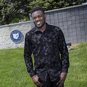 African-American male smiling at camera, COTC student Maxwell Doku