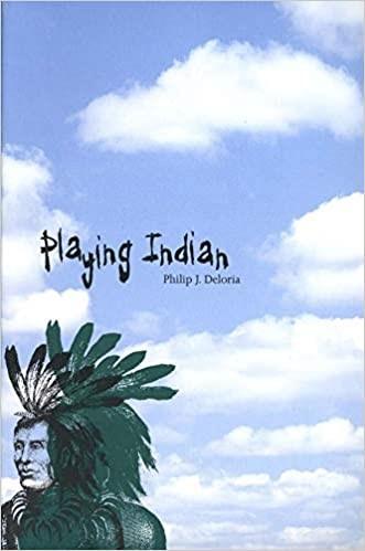 Book Cover Image with title Playing Indian. Clouds in background with image of Native American wearing a feather headdress at forefront.