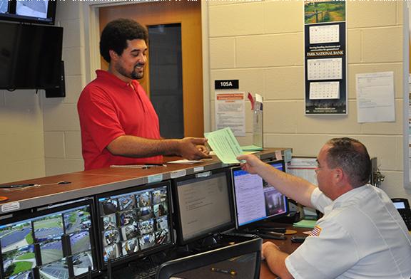 student talking to public safety services personnel