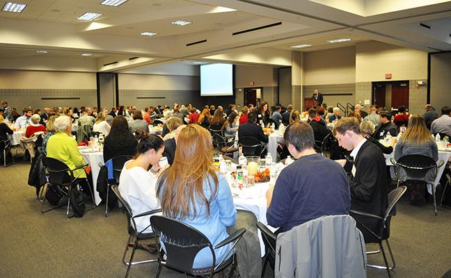 Another image of people eating at the scholarship breakfast