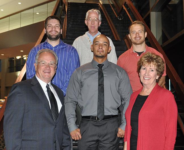 A group of people posing at the scholarship breakfast