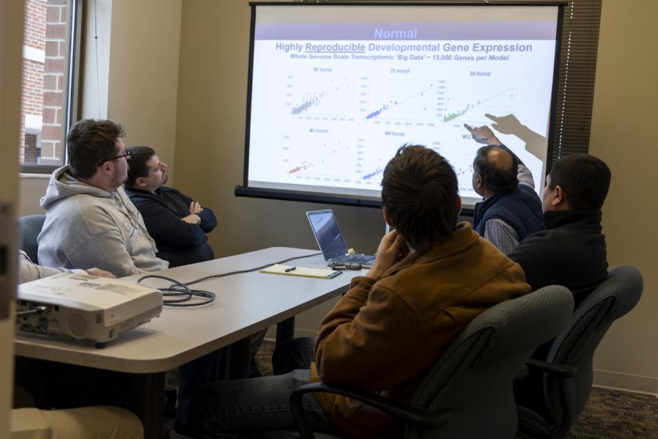 Students watch Rene Anand, PhD, give presentation.