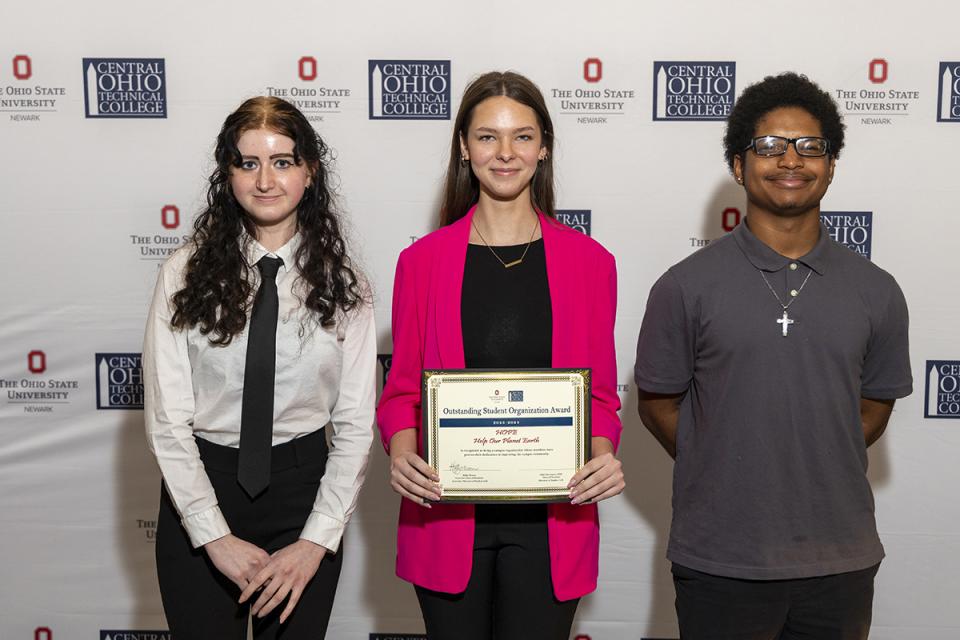 Members of the Hope Cub hold a plaque recognizing their organization as the Outstanding Student Organization.