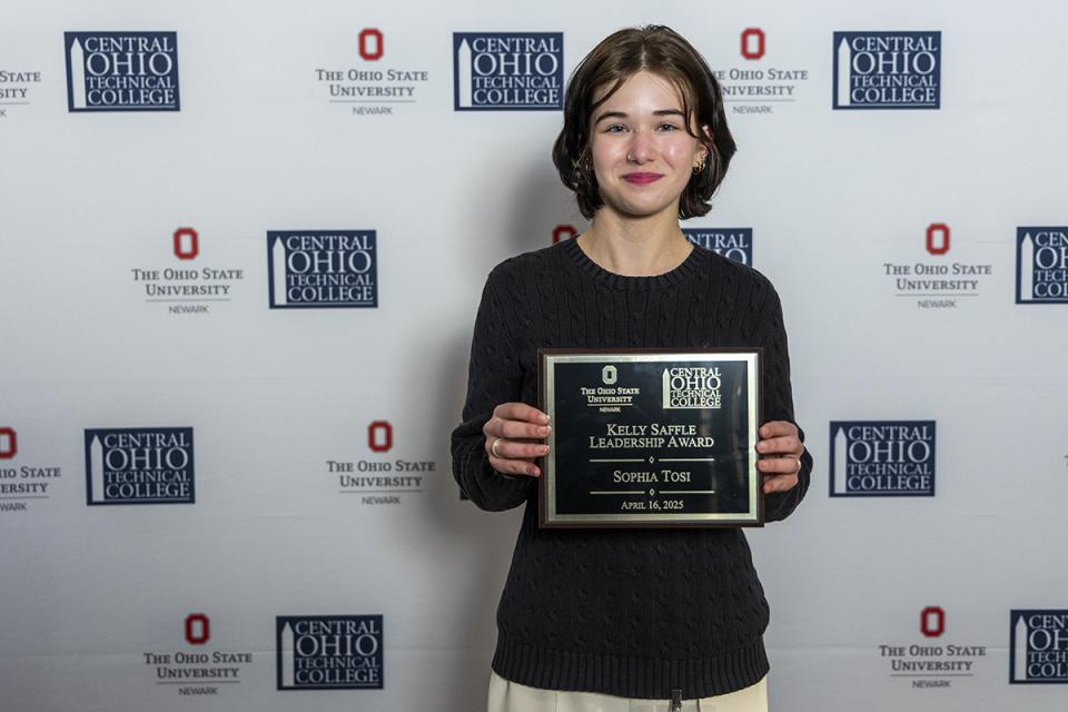 Portrait of Sophia Tosi holding their award plaque.