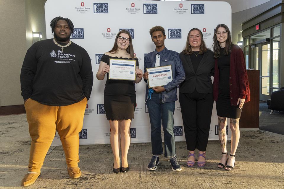 Portrait of members of Campus Activities Board (CAB) and Pride Out Loud student organizations holding their award certificates.