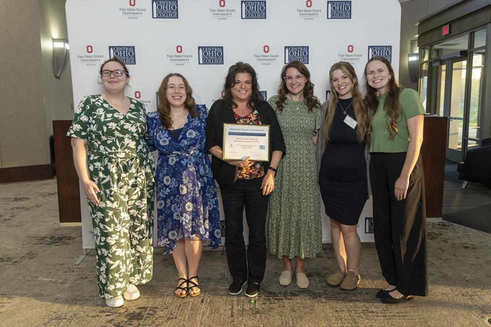 Portrait of the members of the American Sign Language student organization holding their award cerificate.