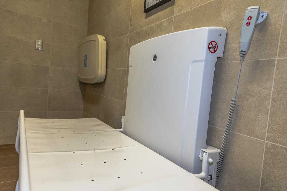 A universal changing station is mounted on a wall.