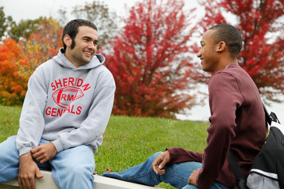 Two students talking in an outdoor setting