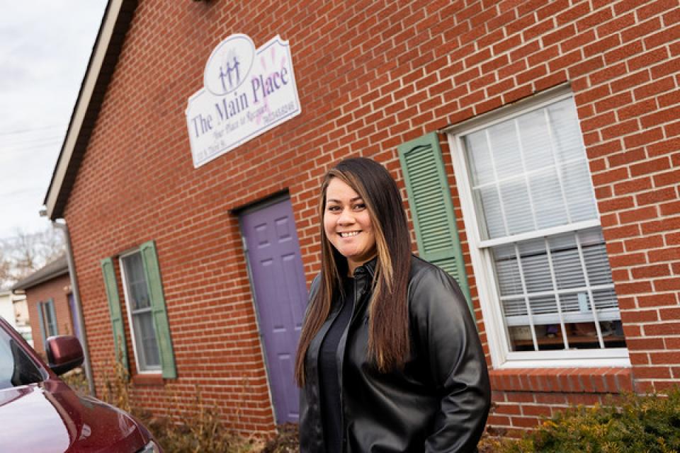 COTC human services graduate Melody Bolin stands outside of The Main Place where she works as a mental health case manager.