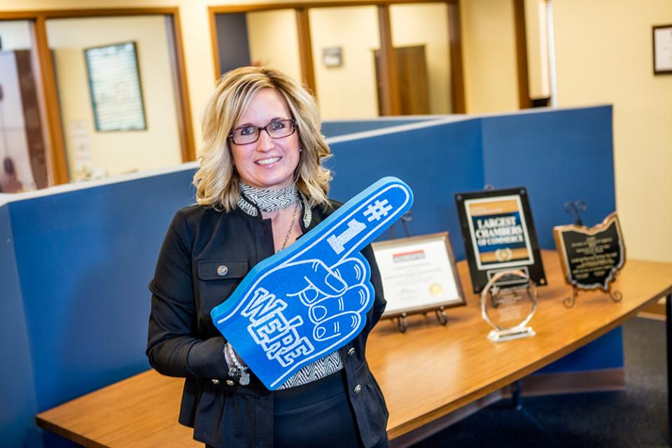 Jennifer McDonald with foam number one finger at the Licking County Chamber of Commerce office.