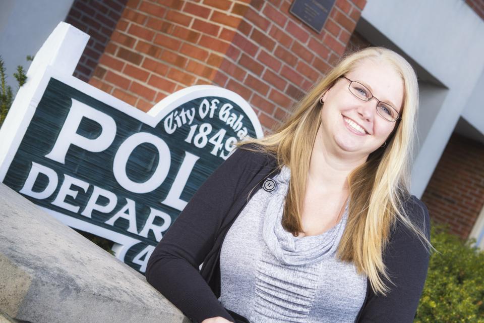 Picture of woman posing outside the police department