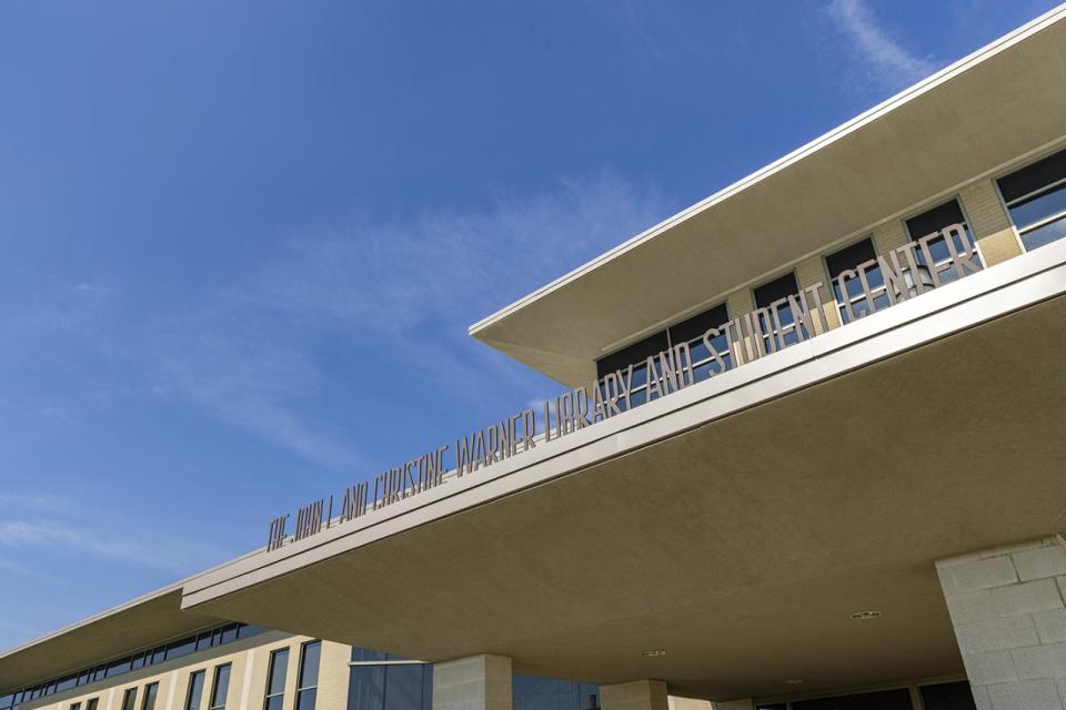 A close-up of the exterior of the Warner Center showing the name on the front side.