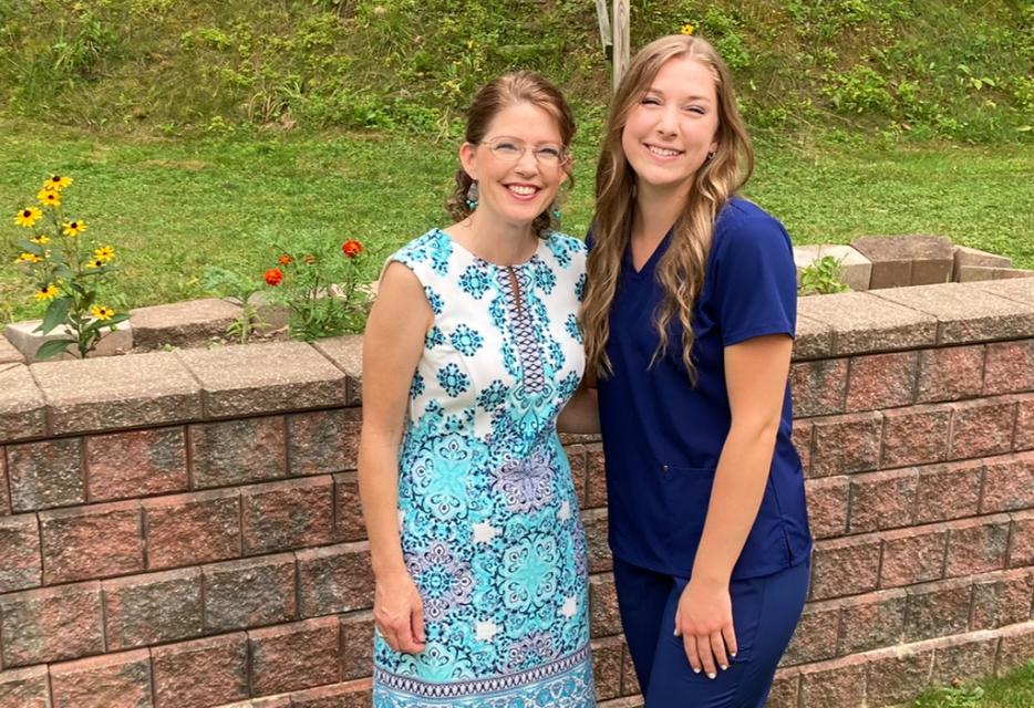 Becca Saxton stands wither her mom on the day of her pinning ceremony at COTC.