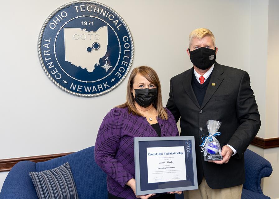 Jodie Wheeler receives her award from COTC President John M. Berry