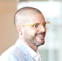 Bald white male smiling at camera, profile shown