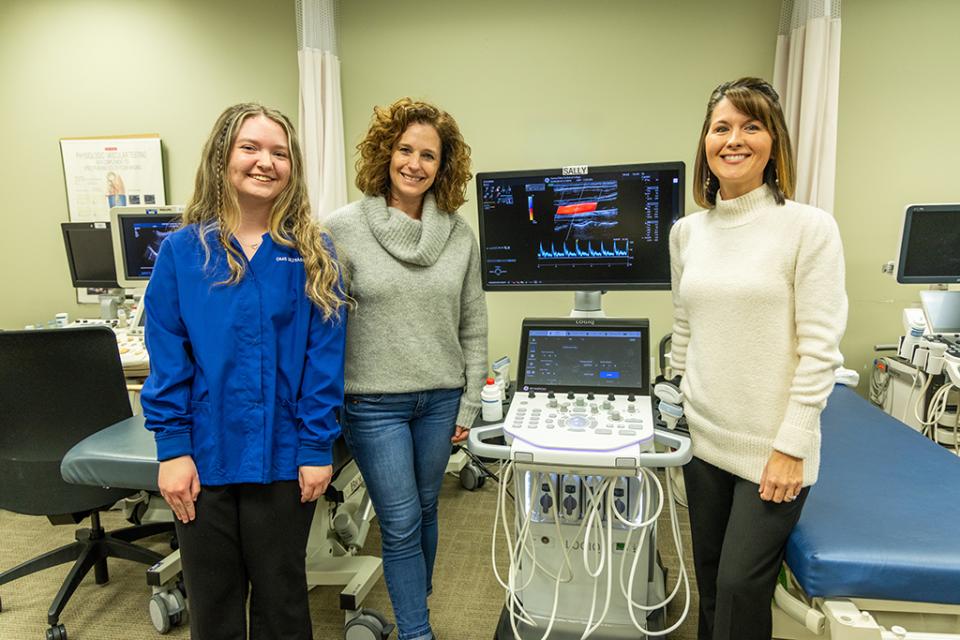 DMS student Sara Potak , donor Sally Heckman, and program director Melinda Brillhart stand around an ultrasound machine donated by Heckman in the COTC sonography lab.