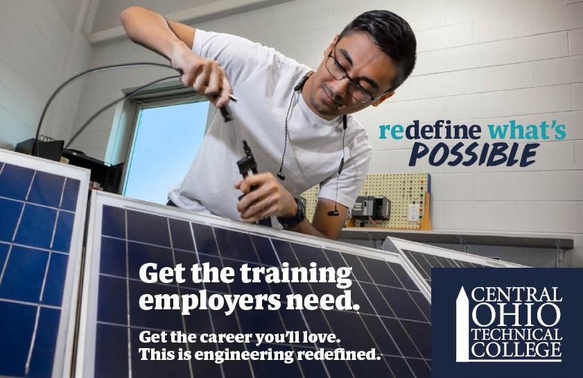 young man of color working on solar panels
