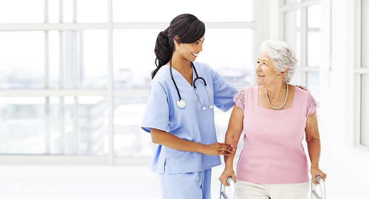 A healthcare professional assists an elderly patient