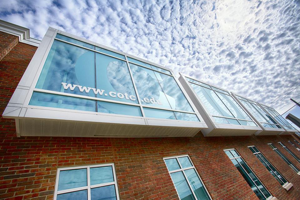 Artistic photo of the windows and sky of a COTC building