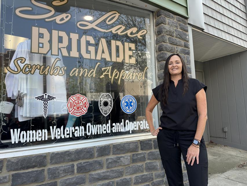 Lacey McCombs stands in front of her storefront in Coshocton. 