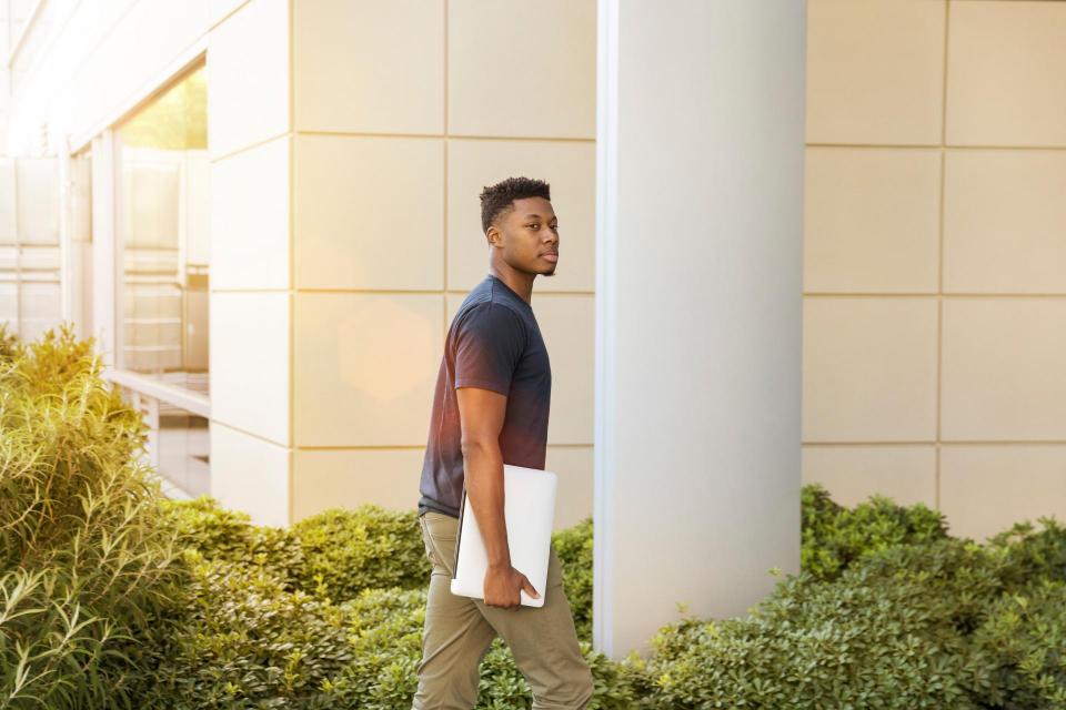 young student walking to a building