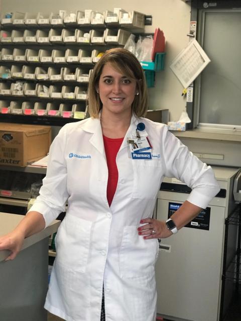 Woman in lab coat smiling at camera