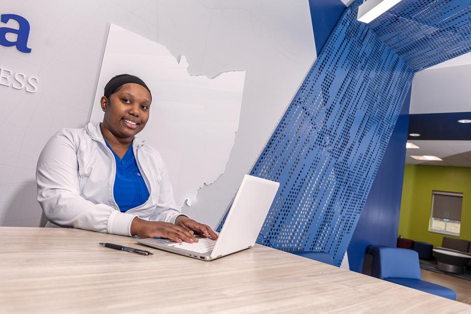 Female student sitting at a laptop  in the Pataskala campus student lounge