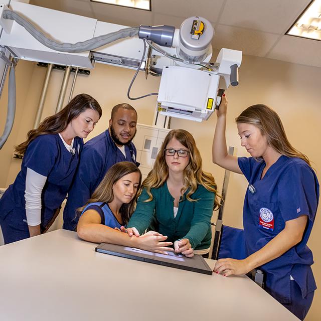 Group of students and professor performing x-ray.